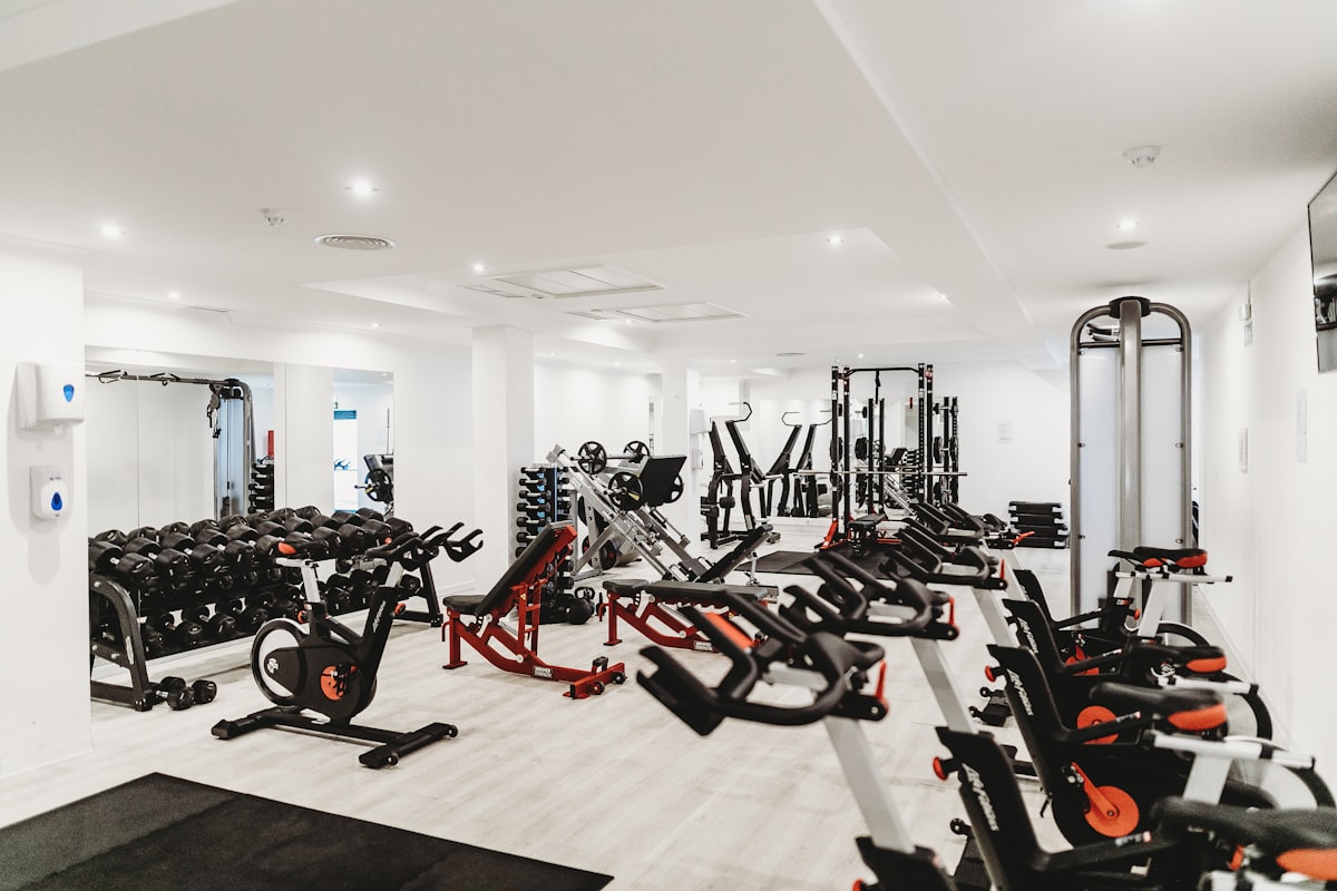 Premium recovery equipment — compression sleeves, foam rollers, and massage tools arranged in recovery lounge